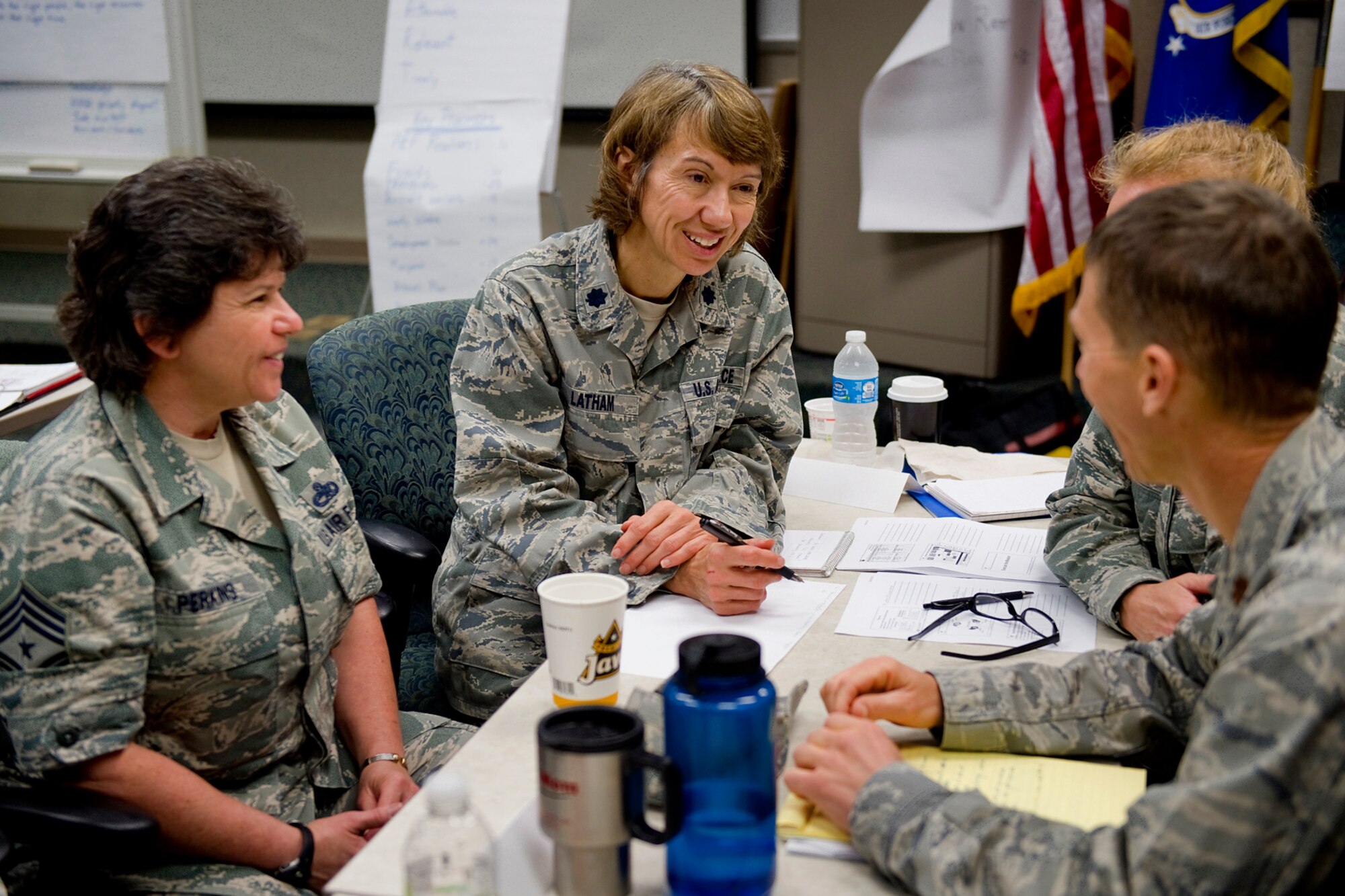 Lt. Col. Patricia Latham, 434th Air Refueling Wing process manager, center, discusses 434th ARW objectives for 2015 with Chief Master Sgt. Karen Perkins, 434th ARW command chief, left; Maj. William Chapman, 434th Maintenance Squadron commander, far right; and Lt. Col. Therese Kern, 434th Aerospace Medicine Squadron commander, behind, during an enterprise value stream analysis and strategic alignment and deployment event here at Grissom Air Reserve Base, Ind. Oct. 27-29, 2014. The primary purpose of the event was to re-evaluate the wing's mission and vision statements, priorities, and objectives for the upcoming year. (U.S. Air Force photo/Mark R. W. Orders-Woempner)