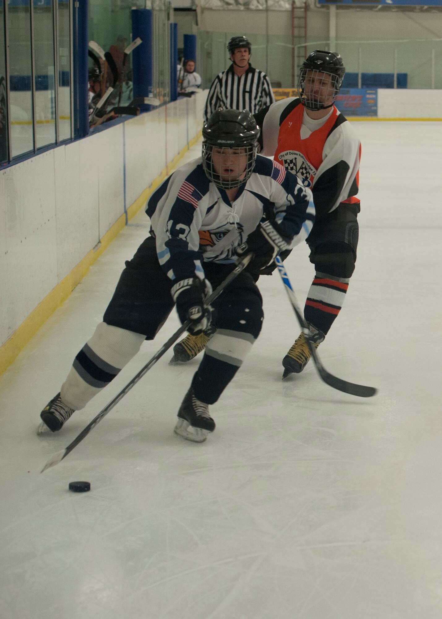 Rumsey Lewis, Eagles right wing, carries the puck down the boards into the offensive zone toward the net during a charity hockey game Jan. 25, 2015, at the Centre Ice Rink in Harrington, Del. This charity game raised $1,400 for COPS (Concerns of Police Survivors). (U.S. Air Force photo/Airman 1st Class Zachary Cacicia) 