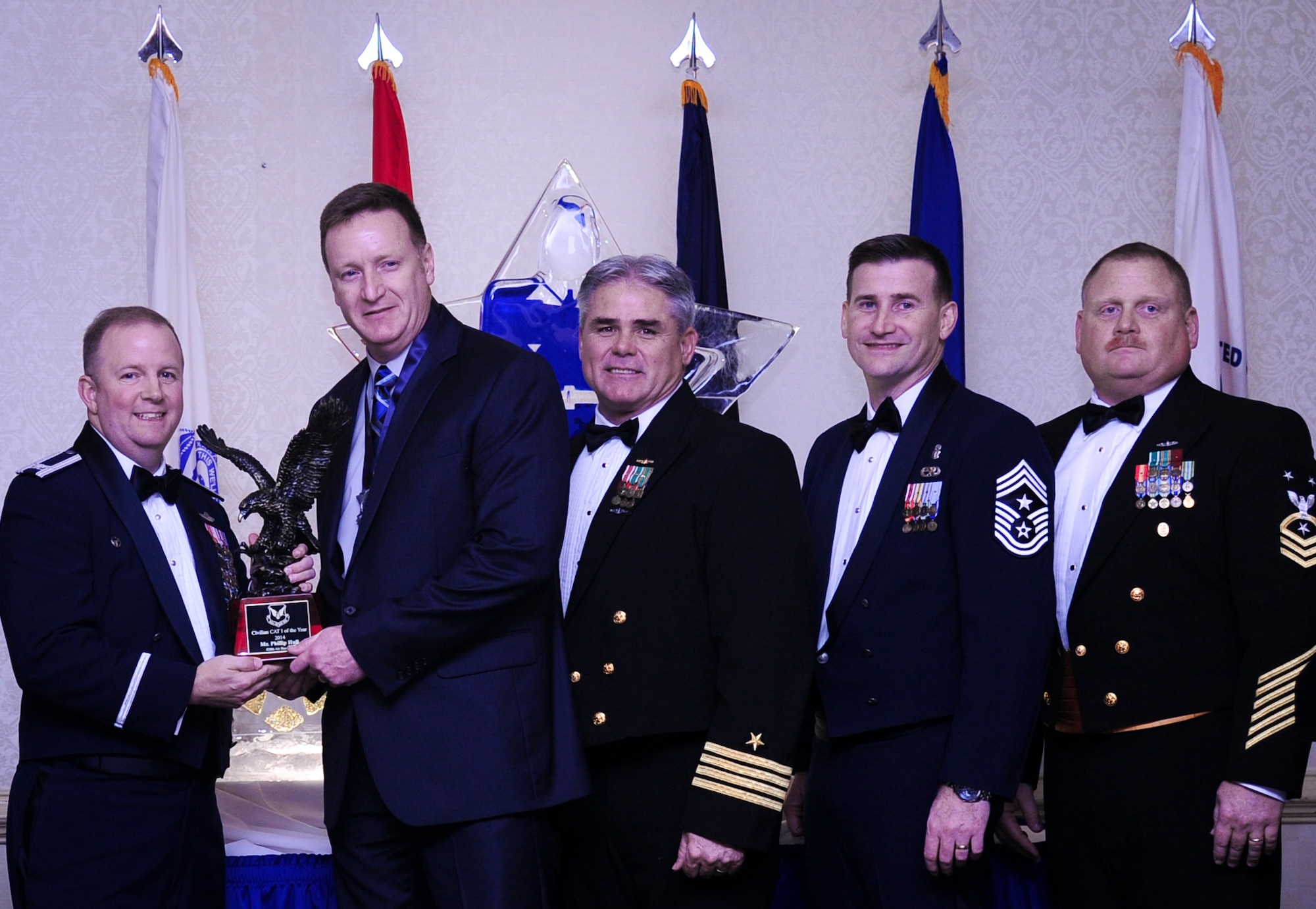 Col. Jeffrey DeVore, Joint Base Charleston commander, Capt. Timothy Sparks, JB Charleston deputy commander, Master Chief Petty Officer Joseph Gardner, Naval Support Activity command master chief and Chief Master Sgt. Mark Bronson, 628th Air Base Wing command chief present Mr. Phillip Hull, 628th Security Forces Squadron, with the Civilian Category I of the Year award Jan. 23, 2015, at the 2015 628th ABW Annual Awards Banquet at the Charleston Club on Joint Base Charleston, S.C. (U.S. Air Force photo/Airman 1st Class Clayton Cupit)