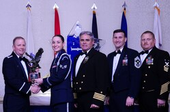 Col. Jeffrey DeVore, Joint Base Charleston commander, Capt. Timothy Sparks, JB Charleston deputy commander, Master Chief Petty Officer Joseph Gardner, Naval Support Activity command master chief and Chief Master Sgt. Mark Bronson, 628th Air Base Wing command chief present Senior Airman Erin Winkler, 437th Aircraft Maintenance Squadron, with the Honor Guard Member of the Year award Jan. 23, 2015, at the 2014 628th ABW Annual Awards Banquet at the Charleston Club on Joint Base Charleston, S.C. (U.S. Air Force photo/Airman 1st Class Clayton Cupit) 
