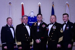 Col. Jeffrey DeVore, Joint Base Charleston commander, Capt. Timothy Sparks, JB Charleston deputy commander, Master Chief Petty Officer Joseph Gardner, Naval Support Activity command master chief and Chief Master Sgt. Mark Bronson, 628th Air Base Wing command chief stand with Master at Arms 2nd Class Brian Cobb, NSA, Junior Sailor of the Year, Jan. 23, 2015, at the 2014 628th ABW Annual Awards Banquet at the Charleston Club on Joint Base Charleston, S.C. (U.S. Air Force photo/Airman 1st Class Clayton Cupit) 
