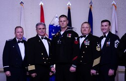 Col. Jeffrey DeVore, Joint Base Charleston commander, Capt. Timothy Sparks, JB Charleston deputy commander, Master Chief Petty Officer Joseph Gardner, Naval Support Activity command master chief and Chief Master Sgt. Mark Bronson, 628th Air Base Wing command chief stand with Master at Arms 1st Class Mark VanWyck, NSA, Senior Sailor of the Year, Jan. 23, 2015, at the 2014 628th ABW Annual Awards Banquet at the Charleston Club on Joint Base Charleston, S.C. (U.S. Air Force photo/Airman 1st Class Clayton Cupit) 

