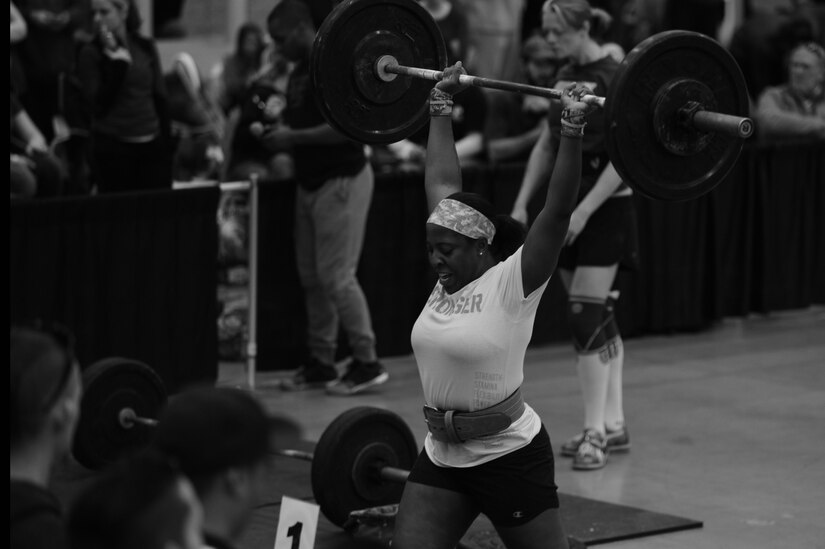 U.S. Air Force Staff Sgt. Paris Roberts, Air Combat Command Public Affairs knowledge operations manager, performs “clean and jerk” during heat two of the TeamGrit CrossFit competition in Hampton, Va., Jan. 17, 2015. This heat included a barbell complex in which competitors had one chance to properly lift as much as they could every minute on the minute for three rounds. (U.S. Air Force photo by Staff Sgt. Natasha Stannard/Released)
