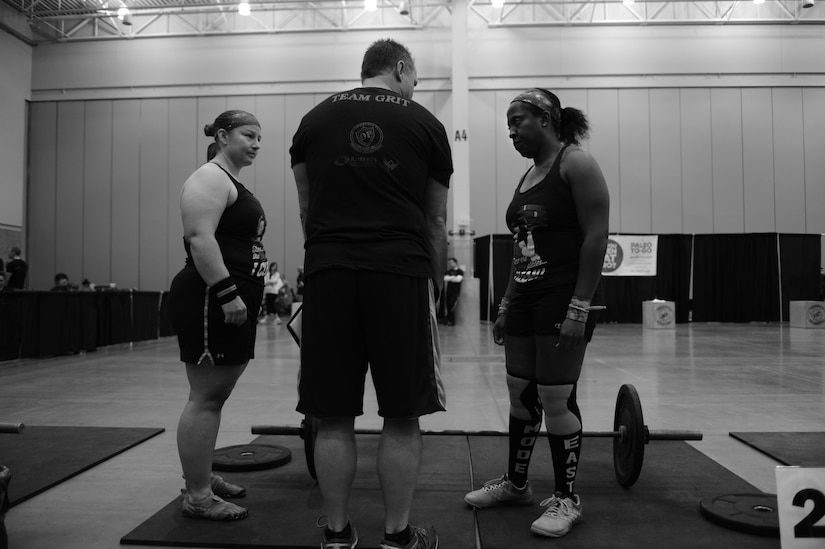 A TeamGrit CrossFit competition judge goes over rules for the first heat of competition with U.S. Air Force Staff Sgt. Paris Roberts, right, and her teammate, Kerri Krasnow Jan. 17, 2015. Roberts is a knowledge operations manager with Air Combat Command Public Affairs at Langley Air Force Base, Va. Roberts trained five days each week to prepare for the competition, and has practiced CrossFit for two years. (U.S. Air Force photo by Staff Sgt. Natasha Stannard/Released)