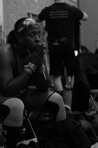 U.S. Air Force Staff Sgt. Paris Roberts, Air Combat Command Public Affairs knowledge operations manager, takes a moment to rest before competing in the TeamGrit CrossFit competition in Hampton, Va., Jan. 17, 2015. This was Roberts first CrossFit competition, after beginning CrossFit training during a deployment to the Middle East in November 2013. (U.S. Air Force photo by Staff Sgt. Natasha Stannard/Released)