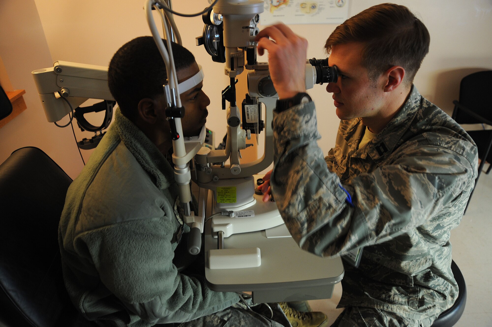 U.S. Air Force Capt. Bryan Crosby, 20th Aerospace Medicine Squadron optometrist, examines the eye of a U.S. Army soldier at Shaw Air Force Base, S.C., Jan. 16, 2014. From Jan. 26-30 the 20th Medical Group is scheduled to celebrate the Biomedical Sciences Corps anniversary. The mission of the BSC is to optimize a high performance fighting force and the health of all they serve. (U.S. Air Force photo by Airman 1st Class Michael Cossaboom/Released)
