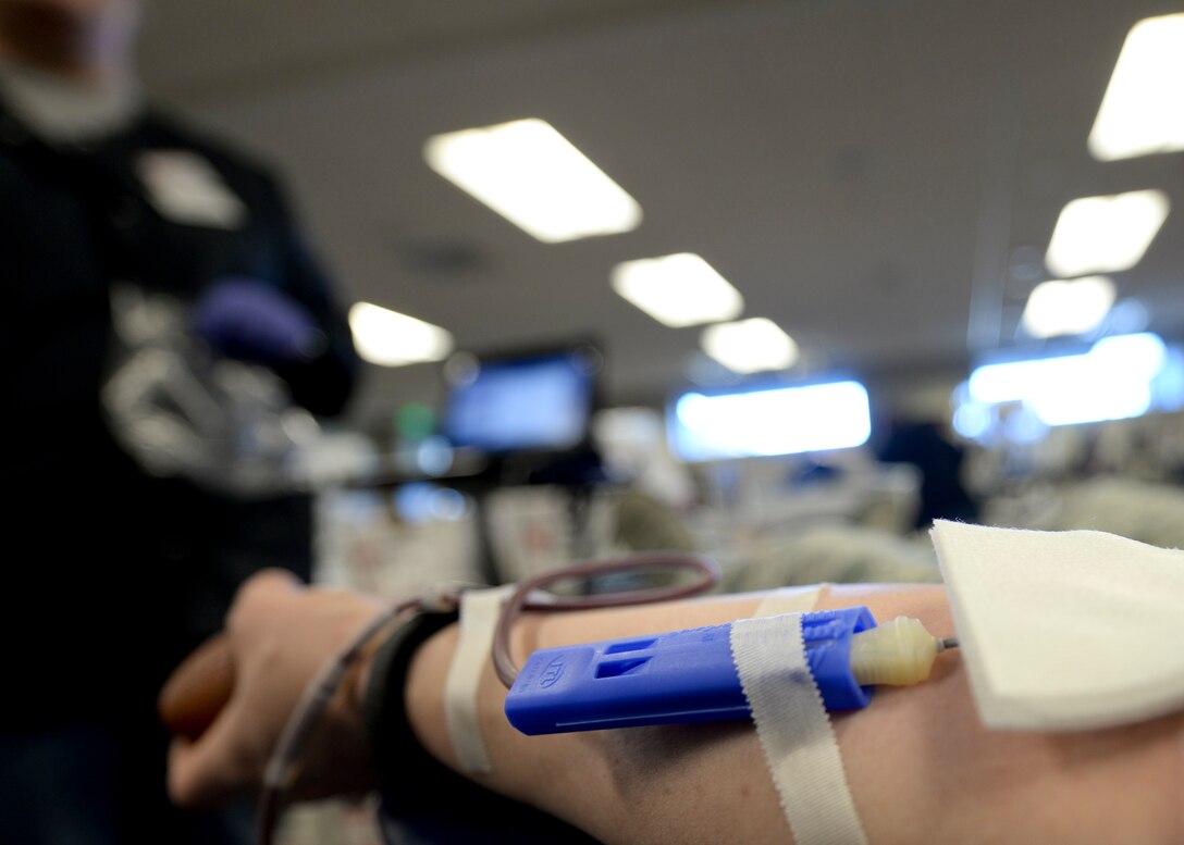 Staff Sgt. Jessica Hykes, Area Defense Counsel defense paralegal, volunteers to donate blood inside the deployment center at Ellsworth Air Force Base, S.D., Jan. 23, 2015. Hykes has donated blood numerous times to help meet the demand for potentially lifesaving blood. (U.S. Air Force photo by Senior Airman Anania Tekurio/Released)  