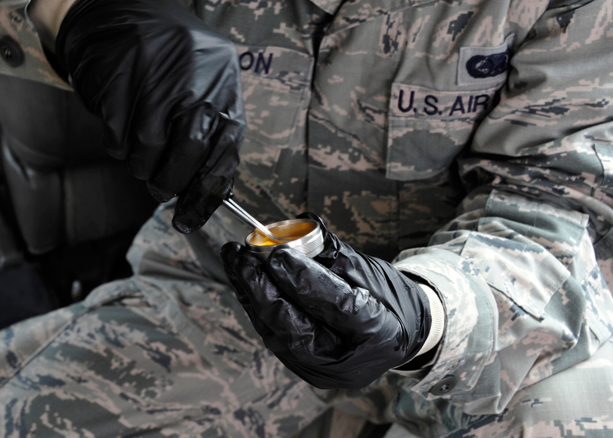 Senior Airman Samuel Fallon, of the 96th Logistics Readiness Squadron, applies a water finding paste to manual gauging tape at the Weekly Bayou fuel ramp on Eglin Air Force Base, Fla., Jan. 15.  The fuels laboratory technicians apply the paste to ensure there is no water in the barge.  The tape is then lowered to the tank bottom and will change color if water is detected.  The 96th Fuels Management Flight provides fuel support to all Eglin units and manages the requisition, receipt, storage, issue, quality and accounting of all petroleum and cryogenic products here.