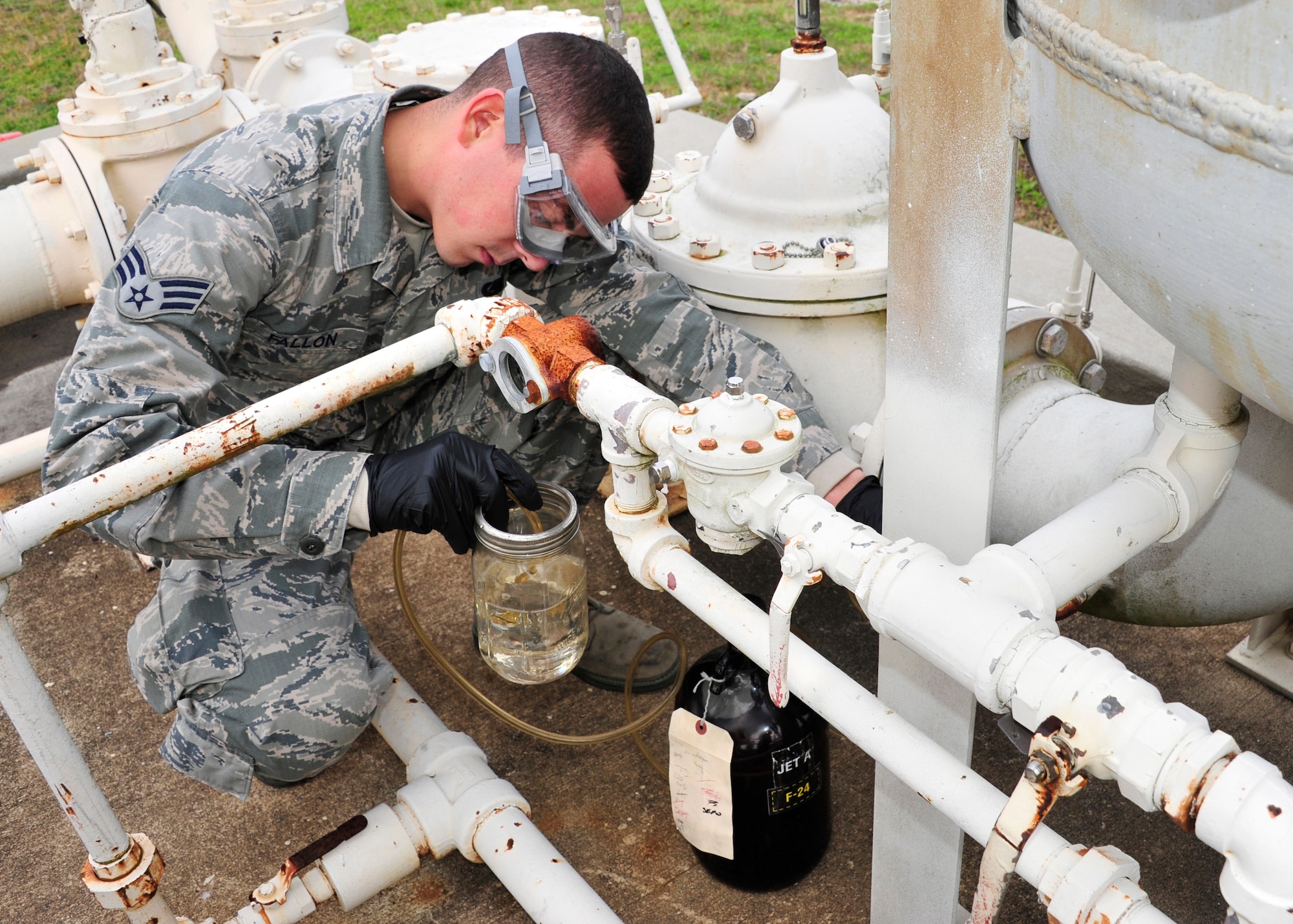 Senior Airman Samuel Fallon, of the 96th Logistics Readiness Squadron, extracts a fuel sample from the filter separator at the Weekly Bayou fuel ramp on Eglin Air Force Base, Fla., Jan. 15.  The fuel laboratory technicians take the samples to ensure the separator is working properly and to ensure the fuel is not contaminated.  The 96th Fuels Management Flight provides fuel support to all Eglin units and manages the requisition, receipt, storage, issue, quality and accounting of all petroleum and cryogenic products here.
