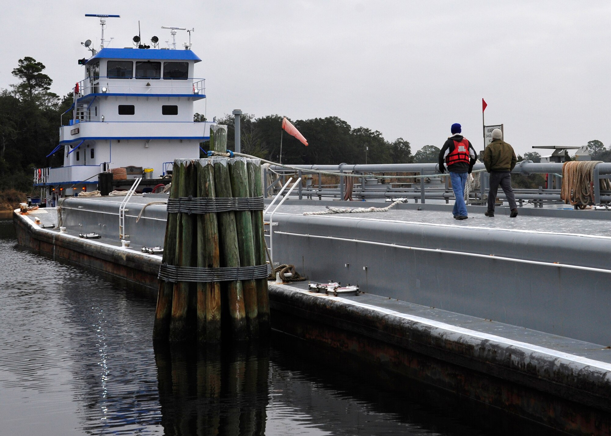 Barge crew members conduct a vessel inspection prior to offloading jet fuel at the Weekly Bayou fuel ramp on Eglin Air Force Base, Fla., Jan. 15.  The 96th Fuels Management Flight provides fuel support to all  Eglin units and manages the requisition, receipt, storage, issue, quality and accounting of all petroleum and cryogenic products here.