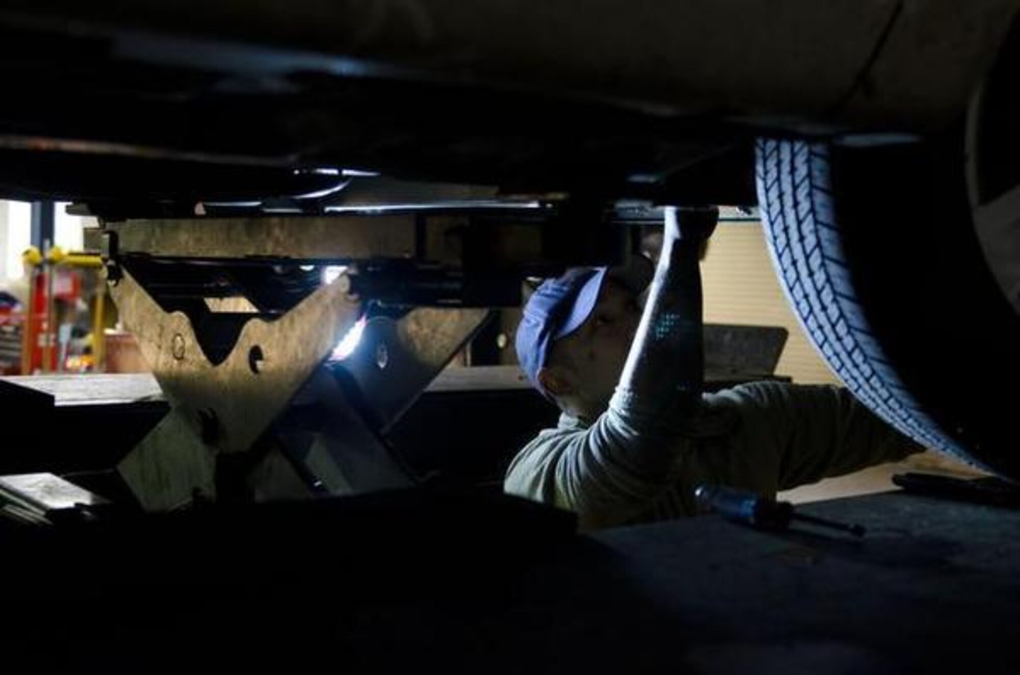 Air Force Staff Sgt. Matt Kahai repairs his power steering line Jan. 14 at the Automotive Skills Center on Lewis Main at JBLM. (19th Public Affairs Detachment/courtesy photo)
