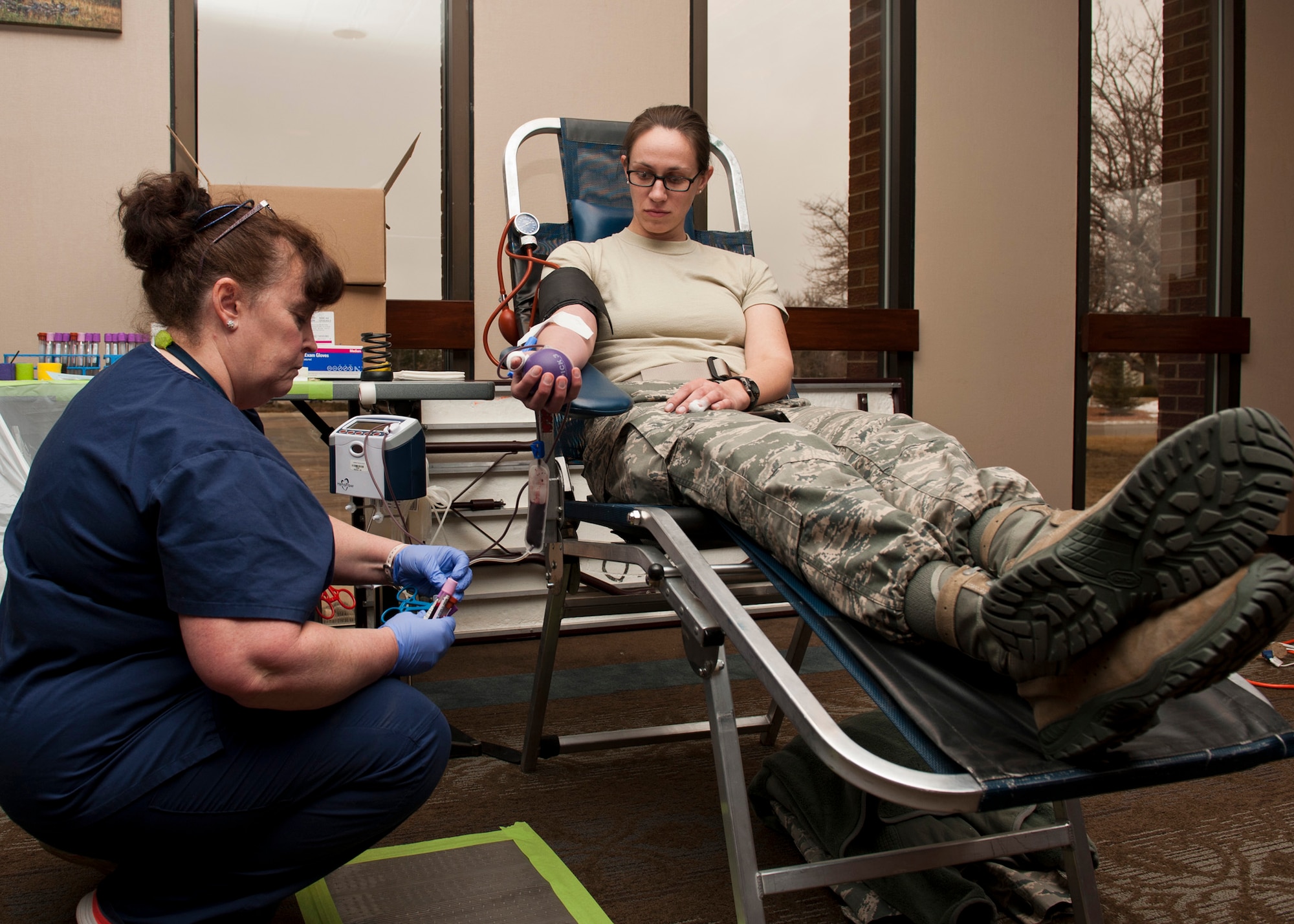 PETERSON AIR FORCE BASE, Colo. – Capt. Katelyn Bries, 21st Space Wing Office of the Staff Judge Advocate assistant staff judge advocate, donates blood during the Bonfils Blood Center blood drive at The Club, Jan. 20, 2015. Bonfils Blood Centers holds approximately three to five blood drives a year on Team Pete and a portion of the blood donated is sent to military hospitals. Thirty eight members donated their blood at the drive. (U.S. Air Force photo by Senior Airman Tiffany DeNault)