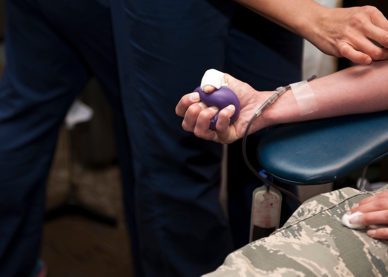 PETERSON AIR FORCE BASE, Colo. – Capt. Katelyn Bries, 21st Space Wing Office of the Staff Judge Advocate assistant staff judge advocate, donates blood during the Bonfils Blood Center blood drive at The Club, Jan. 20, 2015. Bonfils Blood Centers holds approximately three to five blood drives a year on Team Pete and a portion of the blood donated is sent to military hospitals. Thirty eight members donated their blood at the drive. (U.S. Air Force photo by Senior Airman Tiffany DeNault) 