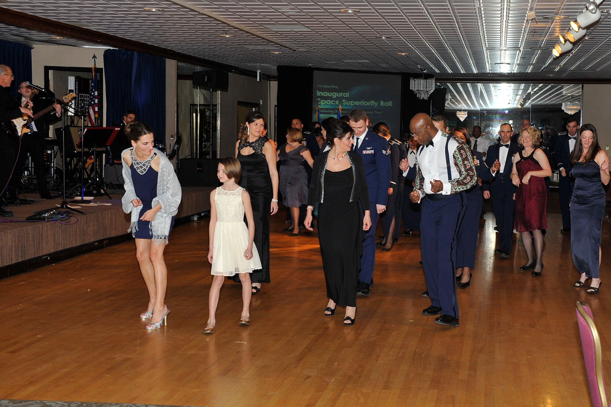 PETERSON AIR FORCE BASE, Colo. -- Airmen and their families dance the night away at the 21st Space Wing’s first-ever space superiority ball Jan. 16 at The Club. The ball was a chance for 21st SW Airmen to celebrate its space and installation support mission in a fun environment. (U.S. Air Force photo by Dennis Howk)