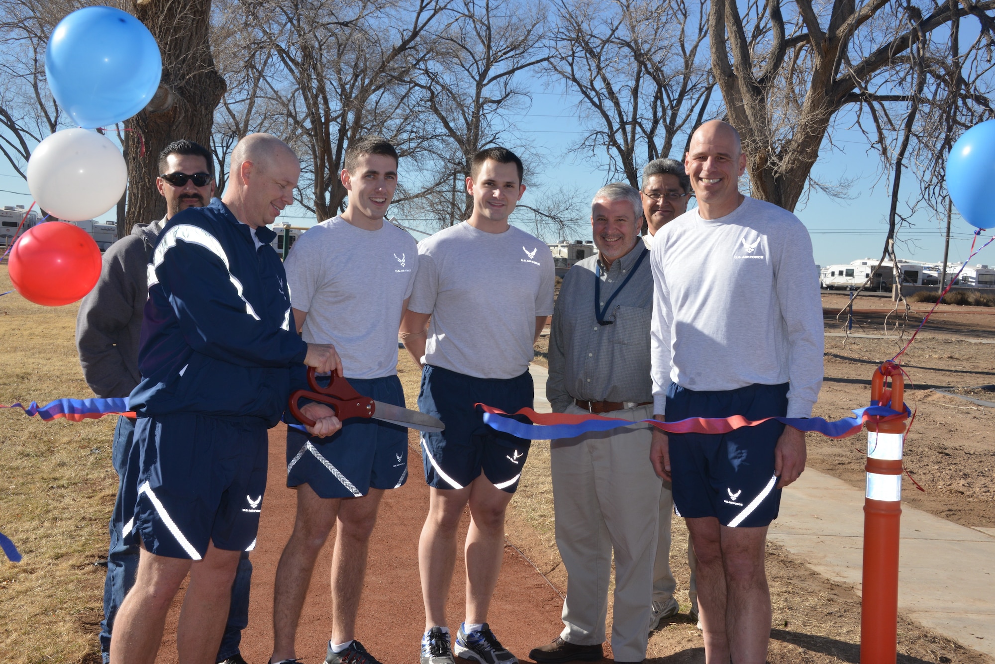 Air Force Research Laboratory Directed Energy Directorate Deputy Director Col. Scott Maethner cuts the ribbon for AFRL’s quality of life fitness park on Jan. 16. Also pictured, from left, are: Filemon Gallegos, US Army Corps of Engineers project manager; 2nd Lt. Nicholas Quartemont; 2nd Lt. Jonathan Dillon; Barry Bunn, Space Vehicles Directorate deputy director; Michael Gallegos, AFRL Infrastructure Management chief; and Col. David Goldstein, Space Vehicles Directorate director. (Photo by Dennis Carlson)