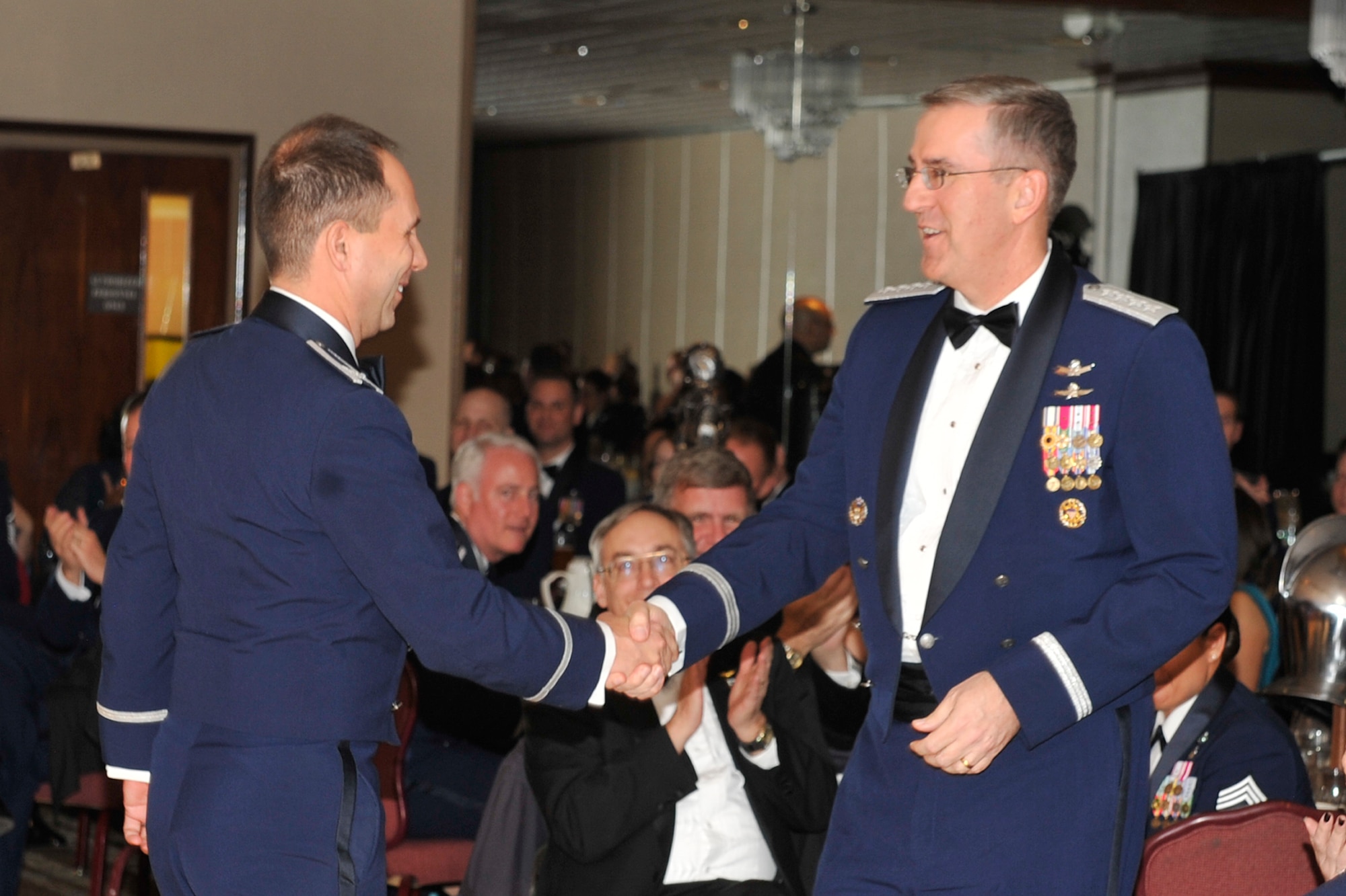 PETERSON AIR FORCE BASE, Colo. -- General John E. Hyten (right), Air Force Space Command commander, shakes hands with Col. John Shaw, 21st Space Wing commander, at the Space Superiority Ball Jan. 16 at The Club. The ball was a chance for 21st SW Airmen to celebrate its space and installation support mission in a fun environment. (U.S. Air Force photo by Dennis Howk)