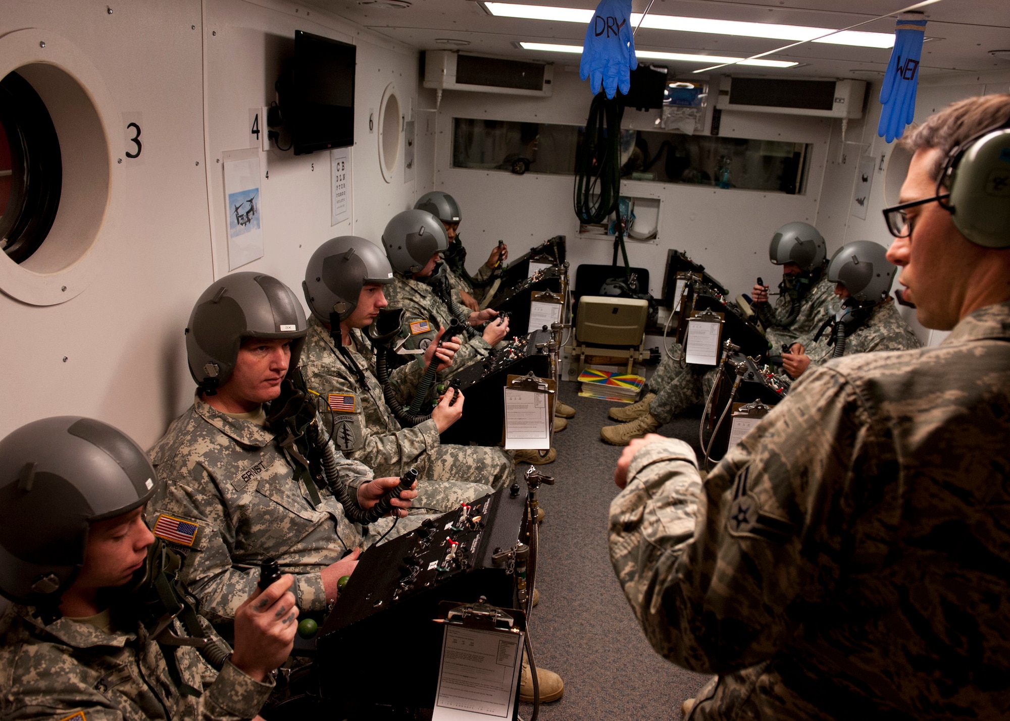 PETERSON AIR FORCE BASE, Colo. – Airman 1st Class Mark McHugh, 21st Aerospace and Operational Physiology, instructs Soldiers from Fort Carson’s 10th Special Forces Group during altitude chamber training, Jan. 15, 2015. During the altitude training course, participants experience the effects of a low-pressure environment and the subtle effects of hypoxia or oxygen deprivation. (U.S. Air Force photo by Senior Airman Tiffany DeNault)
