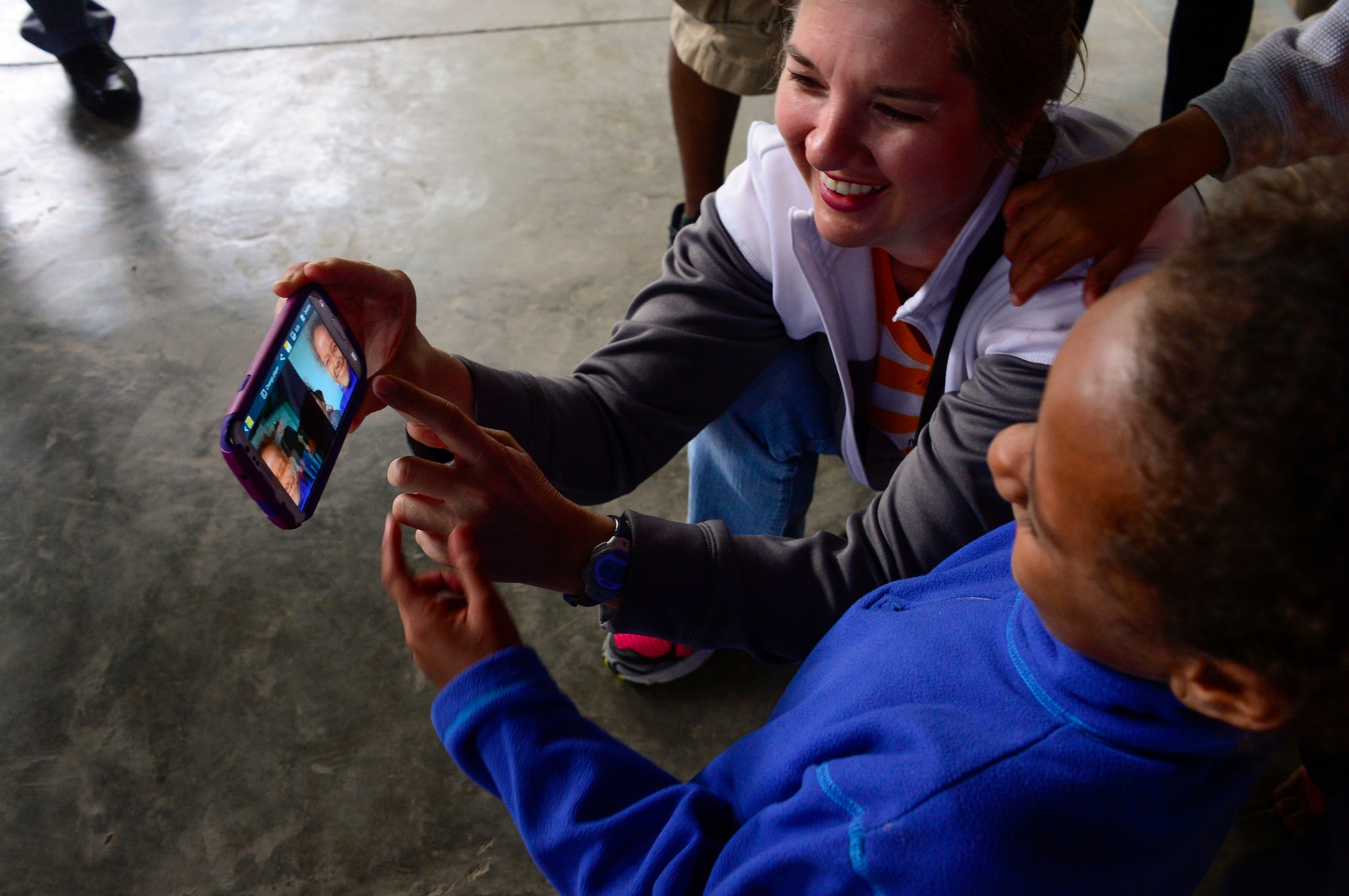 U.S. Army Maj. Rhonda Dyer, assigned to Joint Task Force-Bravo’s Medical Element, shows a young girl how to take a selfie photograph during JTF-Bravo’s visit to at the Sisters of Charity Orphanage in Comayagua, Honduras, Jan. 25, 2015. The Sisters of Charity Orphanage is one of seven different orphanages from around the Comayagua Valley that the U.S. military personnel assigned to JTF-Bravo have supported over the past 17 years. In addition to spending time with interacting with children, members have also collected and donated much-needed supplies and food, as well as helped in minor construction work on the buildings in which the children live. (U.S. Air Force photo/Tech. Sgt. Heather Redman)