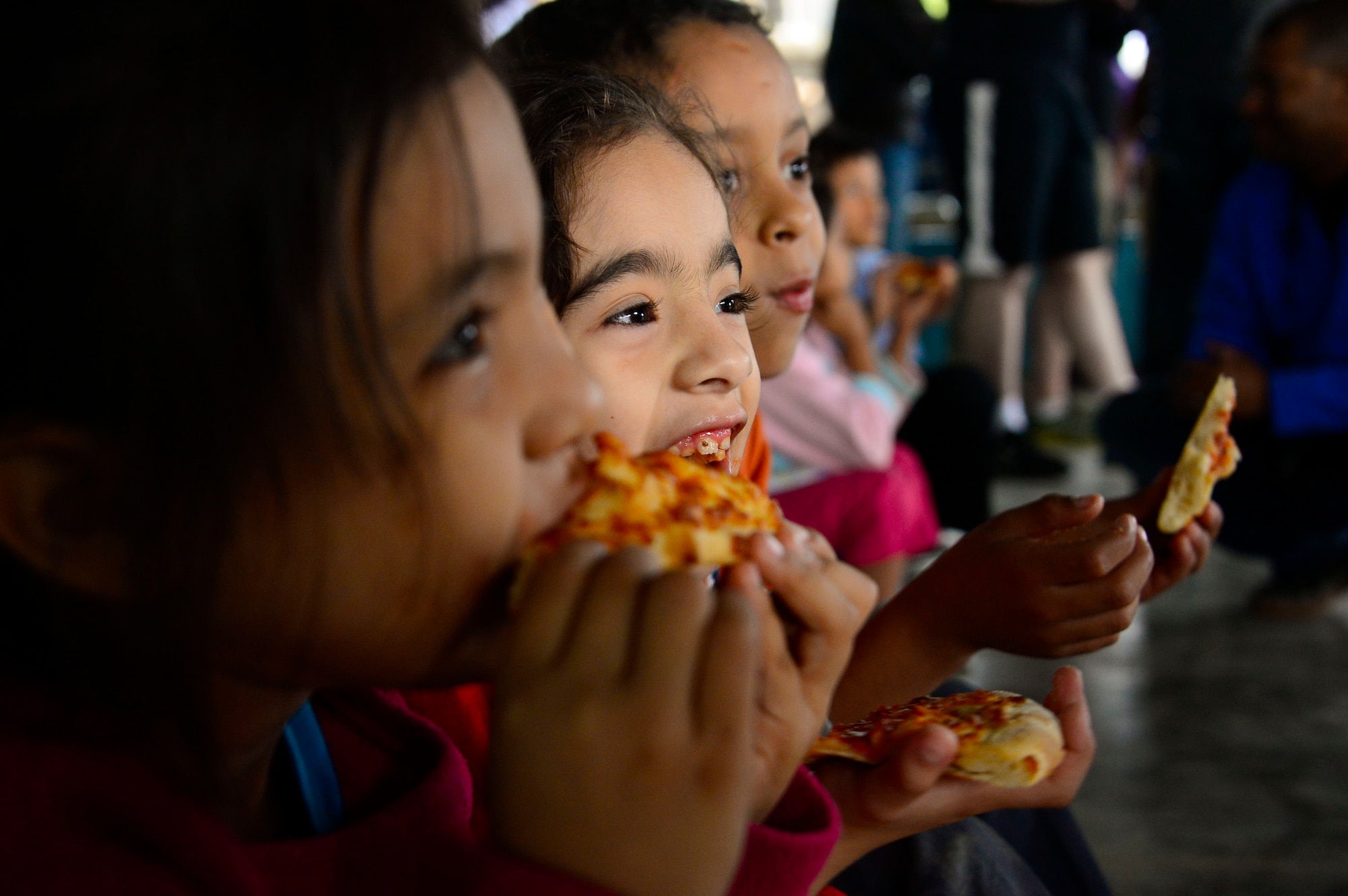 A group of children enjoy their pizza dinner during Joint Task Force-Bravo’s visit to at the Sisters of Charity Orphanage in Comayagua, Honduras, Jan. 25, 2015. The Sisters of Charity Orphanage is one of seven different orphanages from around the Comayagua Valley that the U.S. military personnel assigned to JTF-Bravo have supported over the past 17 years. In addition to spending time with interacting with children, members have also collected and donated much-needed supplies and food, as well as helped in minor construction work on the buildings in which the children live. (U.S. Air Force photo/Tech. Sgt. Heather Redman)