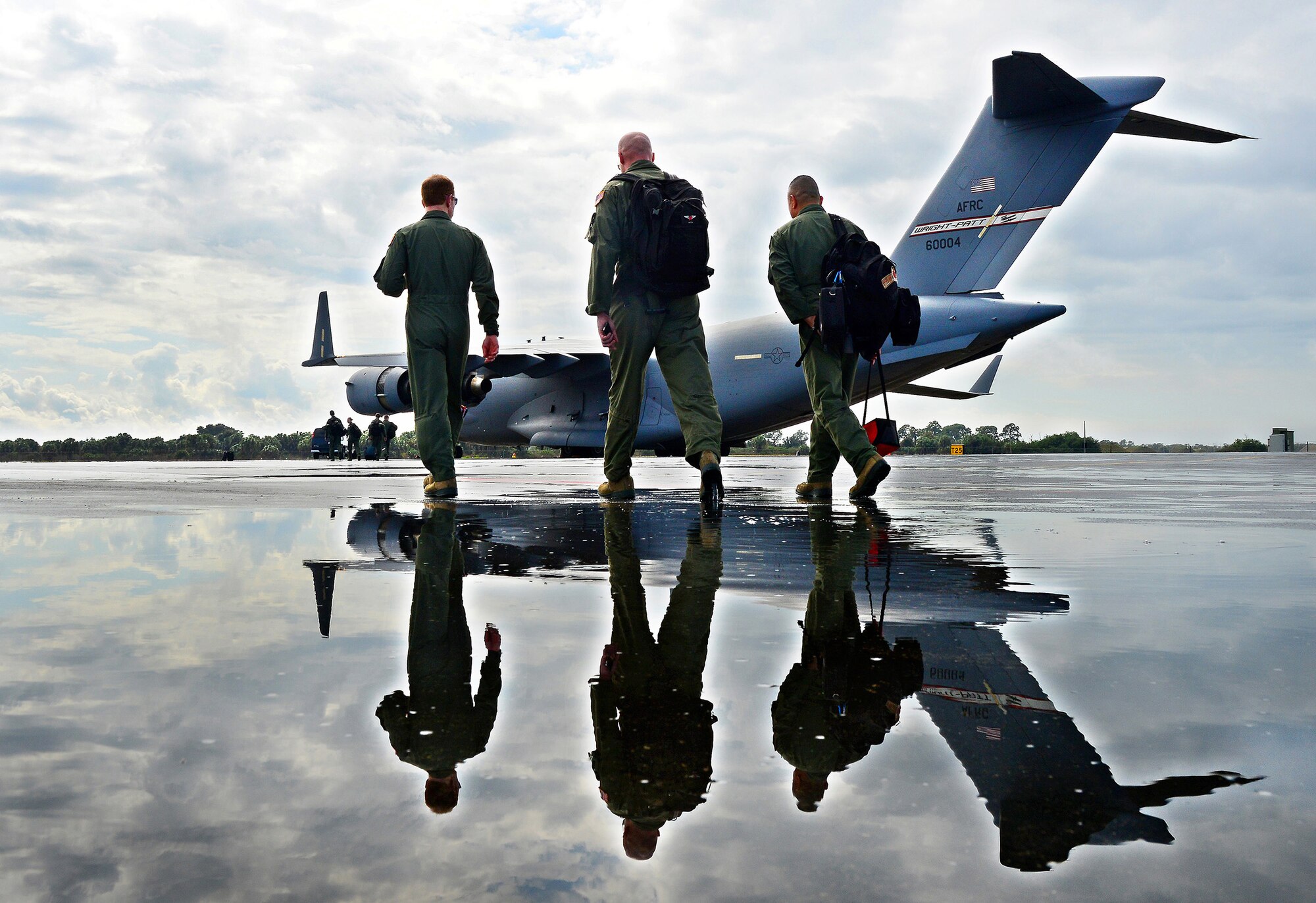 WRIGHT-PATTERSON AIR FORCE BASE, Ohio – Tech. Sgt. Frank Oliver, 445th Airlift Wing Public Affairs photographer, won in four categories of the 2014 Air Force Reserve Command Media Contest. He took third place in the Feature Photograph category of this photo of 445th Aeromedical Evacuation Squadron Airmen stepping out to a 445th Airlift Wing C-17 Globemaster III in preparation for a training mission enroute to Florida. (U.S. Air Force photo/Tech. Sgt. Frank Oliver)