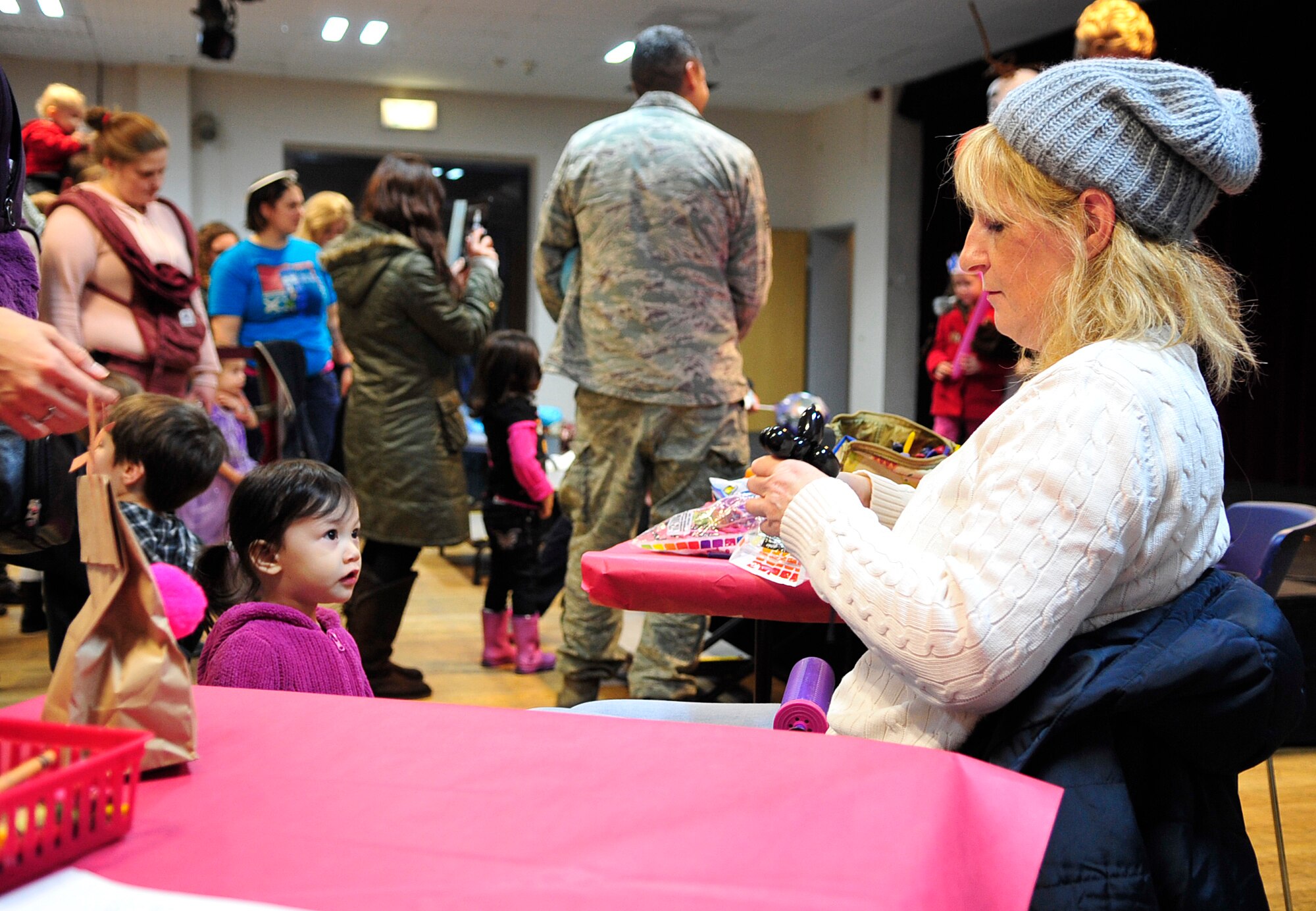 A balloon artist creates balloon animals for children during the “Frozen” family event, Jan. 26, 2015 at the Ramstein Community Center on Ramstein Air Base, Germany. Children and their families had the opportunity to meet one of the movie’s characters, Olaf, as well as make arts and crafts. (U.S. Air Force photo/Airman 1st Class Larissa Greatwood)
