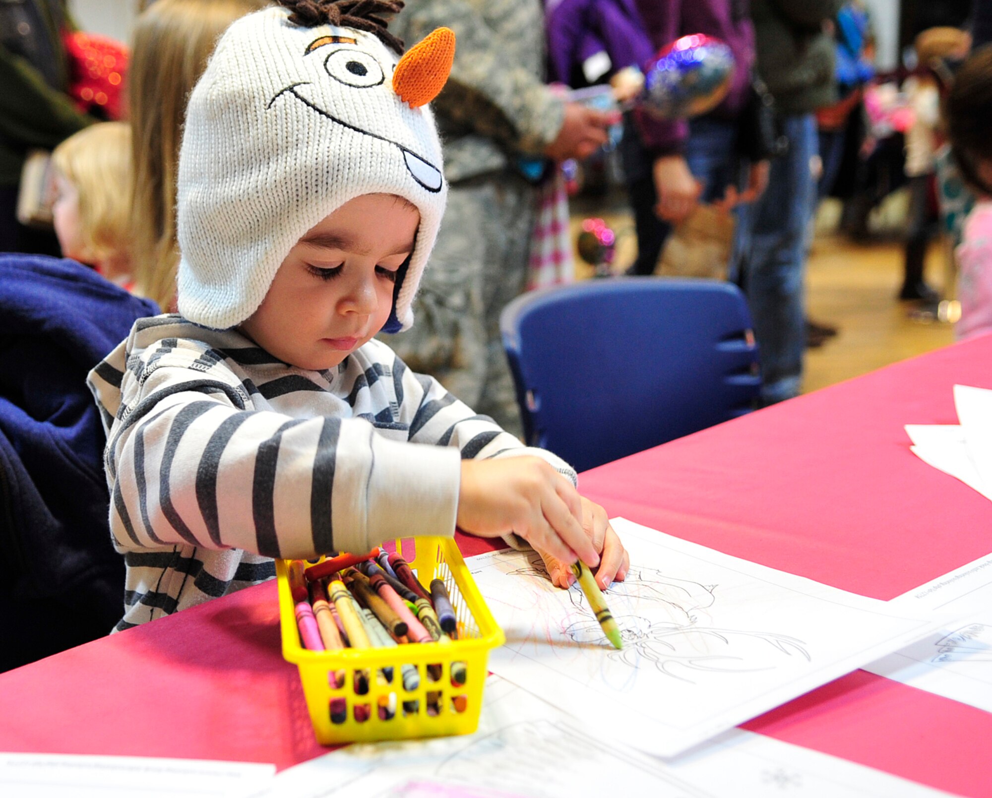 Wyatt Williams, son of Julia and Master Sgt. Joseph Williams, colors a picture of a character from the movie “Frozen” during the “Frozen” family event, Jan. 26, 2015 at the Ramstein Community Center on Ramstein Air Base, Germany. The event included a bouncy house, arts and crafts and a meet-and-greet with the character, Olaf. (U.S. Air Force photo/Airman 1st Class Larissa Greatwood)