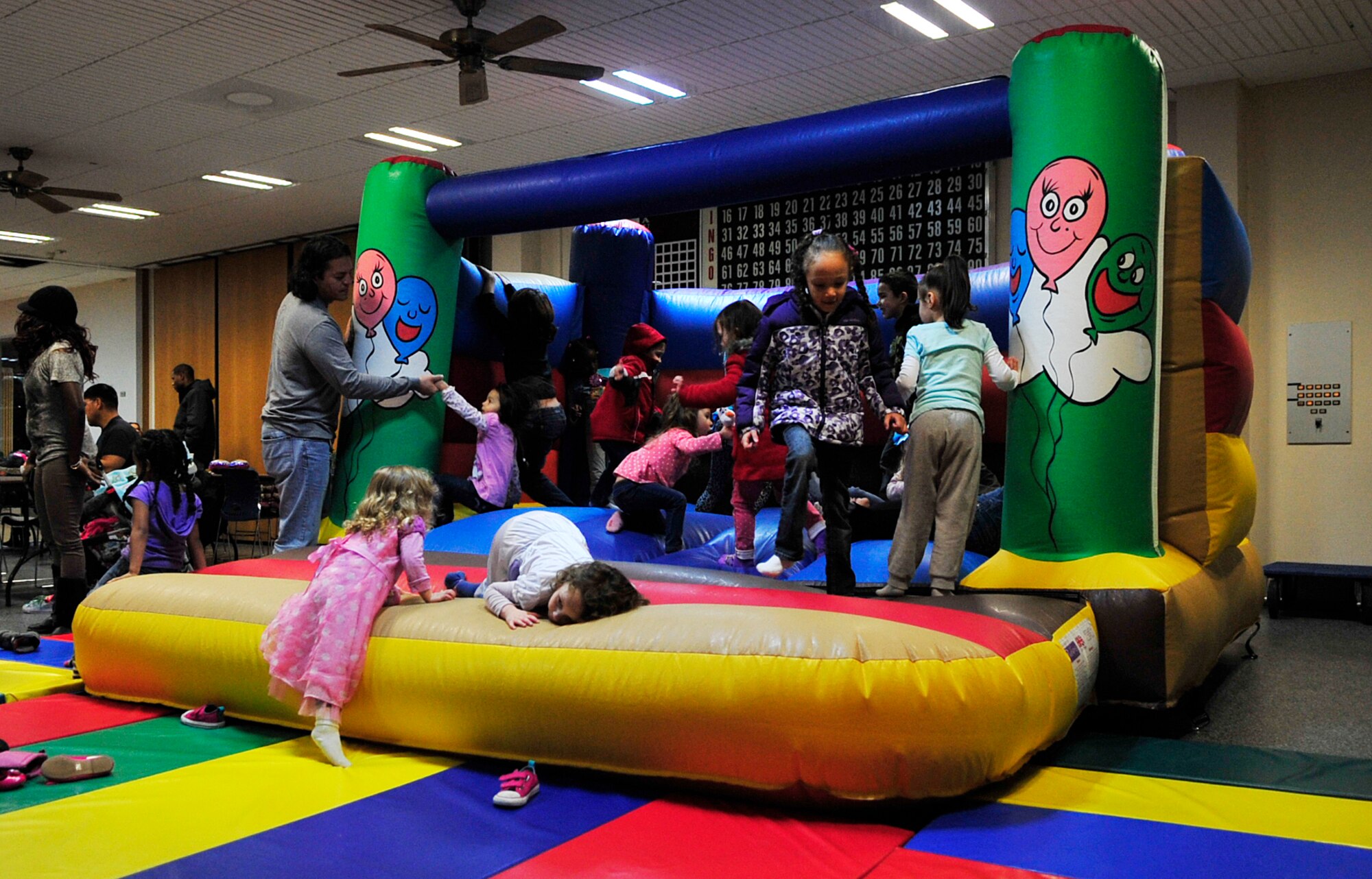 Children jump in the bouncy castle at the “Frozen” family event, Jan. 26, 2015 at the Ramstein Community Center on Ramstein Air Base, Germany. The event included a bouncy house, arts and crafts and a meet-and-greet with the character, Olaf. (U.S. Air Force photo/Airman 1st Class Larissa Greatwood)