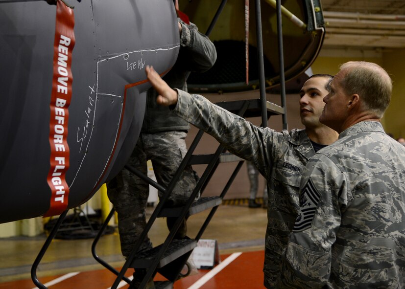 Senior Airman Cody Lechner, 2nd Maintenance Squadron phase inspection journeyman, explains to Chief Master Sgt. of the Air Force James Cody the process of identifying discrepancies on a B-52H Stratofortress on Barksdale Air Force Base, La., Jan. 23, 2015. Cody received a tour of the Phase Hangar and met with Airmen who perform maintenance on the aircraft and discussed their jobs and resiliency. (U.S. Air Force photo/Senior Airman Joseph A. Pagán Jr.)