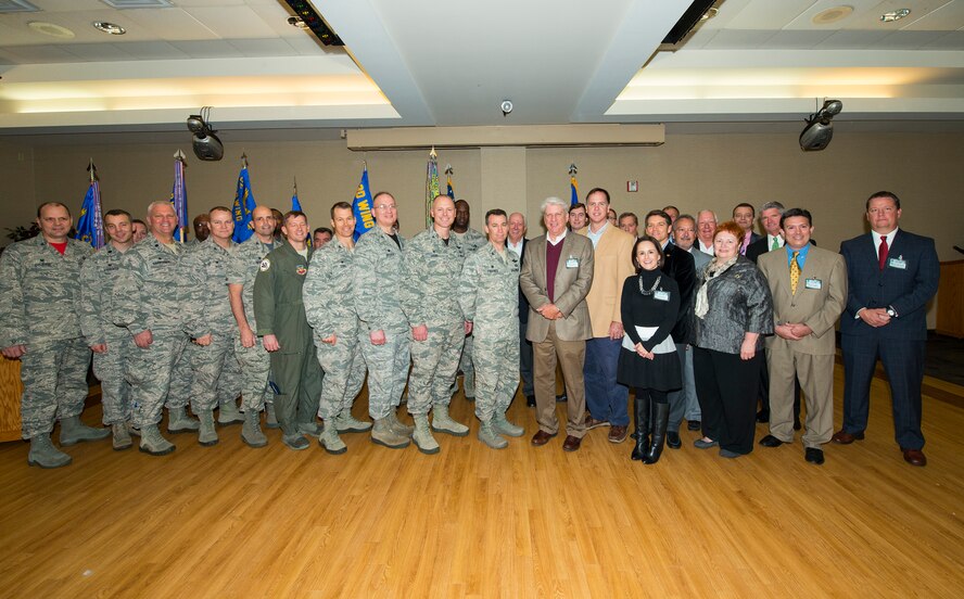 Several Team Moody commanders and honorary commanders pose for a photo during the Honorary Commander assumption of command ceremony Jan. 23, 2015, at Moody Air Force Base, Ga. Honorary commanders bridge the gap between the local and military communities. (U.S. Air Force photo by Airman 1st Class Ceaira Tinsley/Released)