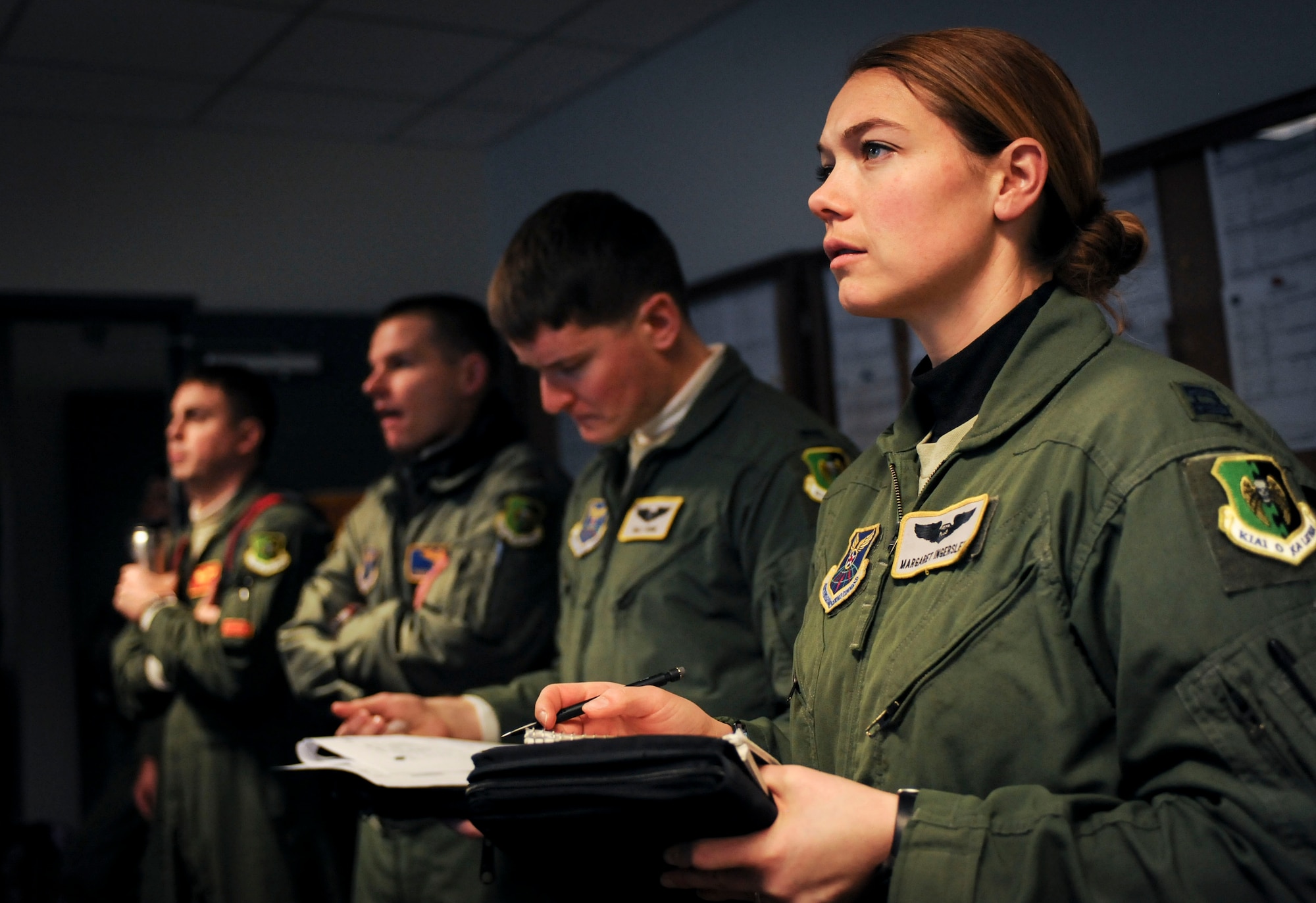 Capt. Margaret Ingerslew, B-52H Stratofortress navigator, takes notes during a preflight briefing on Minot Air Force Base, N.D., Jan. 22, 2015. Approximately six crews received briefings along with Ingerslew before beginning a 12 hour sortie. (U.S. Air Force photo/Senior Airman Stephanie Morris)