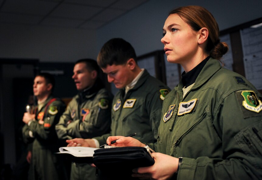 Capt. Margaret Ingerslew, B-52H Stratofortress navigator, takes notes during a preflight briefing on Minot Air Force Base, N.D., Jan. 22, 2015. Approximately six crews received briefings along with Ingerslew before beginning a 12 hour sortie. (U.S. Air Force photo/Senior Airman Stephanie Morris)