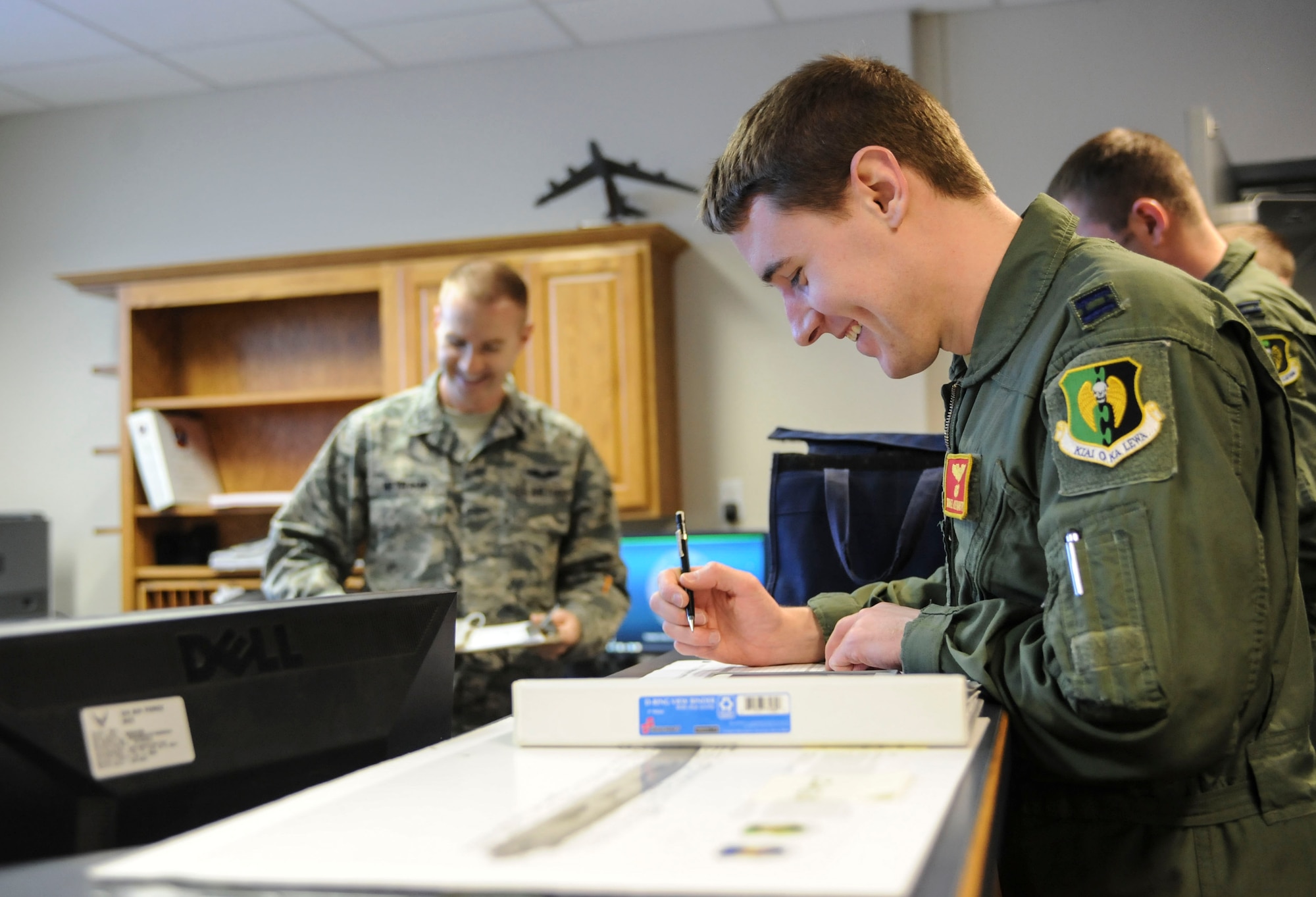Capt. Michael Fleharty, B-52H Stratofortress pilot, takes notes during a preflight briefing on Minot Air Force Base, N.D., Jan. 22, 2015. Approximately six crews received briefings along with Fleharty before beginning a 12 hour sortie. (U.S. Air Force photo/Senior Airman Stephanie Morris)