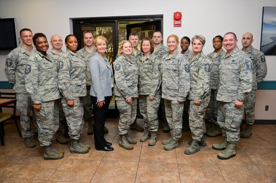 Retired Chief Master Sgt. Athena Cody poses for a photo with 2nd Bomb Wing SNCOs on Barksdale Air Force Base, La., Jan. 22, 2015. Cody stressed the importance senior enlisted spouses play in accomplishing the mission while balancing family. (U.S. Air Force photo/Senior Airman Benjamin Raughton)