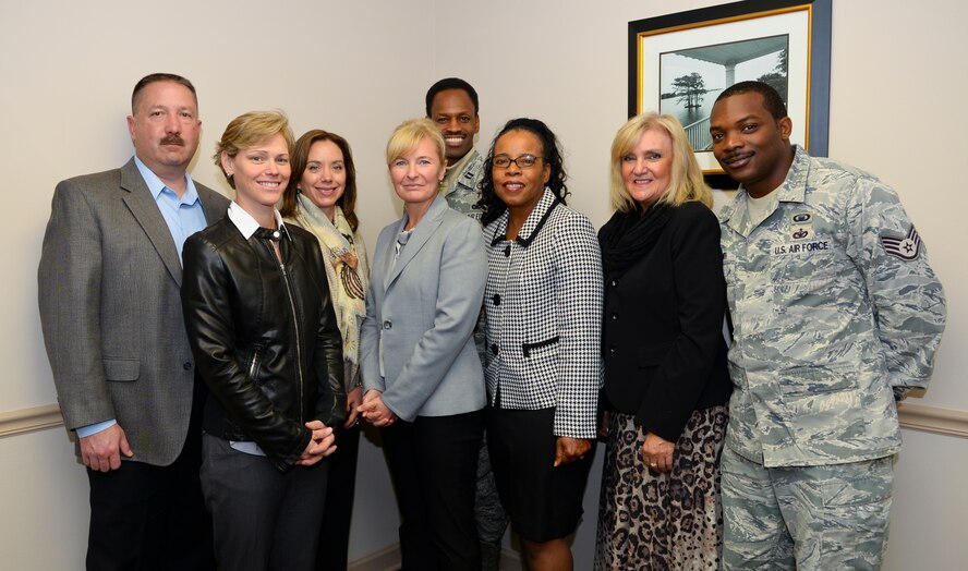 Retired Chief Master Sgt. Athena Cody poses for a photo with members of the Airman & Family Readiness Center and Chaplain corps during a support agency briefing on Barksdale Air Force Base, La., Jan. 22, 2015. The briefing was an opportunity for Cody to dialogue with A&FRC support agencies and gain an understanding of the morale and climate of Barksdale families. (U.S. Air Force photo/Senior Airman Benjamin Raughton)