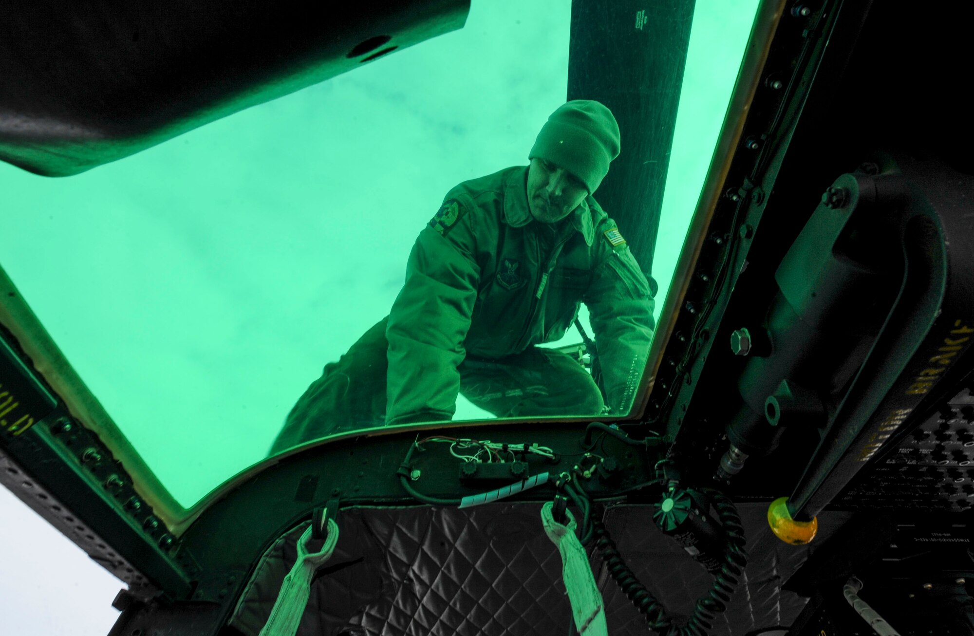 Tech. Sgt. Scott Grubaugh, 54th Helicopter Squadron special mission aviator, climbs down from the top of a UH-1N helicopter after inspecting its rotor system on Minot Air Force Base, N.D., Jan. 21, 2014. Before flight, thorough checks are conducted both inside and outside of the aircraft to ensure it is mission ready. (U.S. Air Force photo/Senior Airman Stephanie Morris)