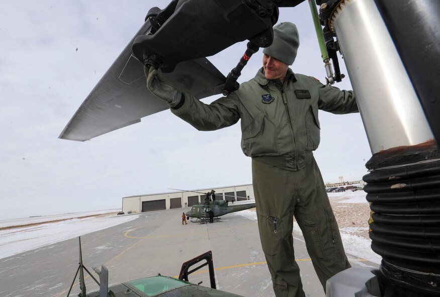 Tech. Sgt. Scott Grubaugh, 54th Helicopter Squadron special mission aviator, inspects the rotor system of a UH-1N helicopter on Minot Air Force Base, N.D., Jan. 21, 2014. Before flight, thorough checks are conducted both inside and outside of the aircraft to ensure it is mission ready. (U.S. Air Force photo/Senior Airman Stephanie Morris)