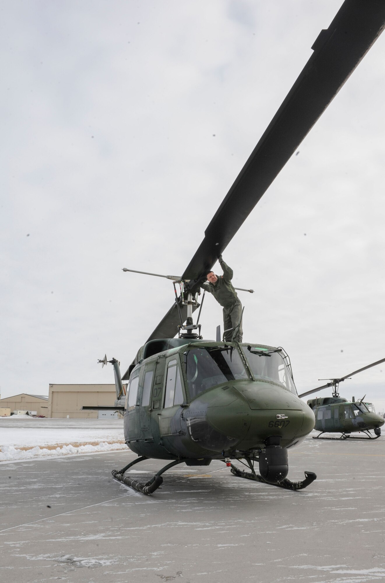 Master Sgt. Jordan Bunting, 54th Helicopter Squadron special mission aviators, inspects the propeller of a UH-1N helicopter on Minot Air Force Base, N.D., Jan. 21, 2014. Bunting checked for any damage to the propeller and rotor system to ensure the safety of the crew during flight. (U.S. Air Force photo/Senior Airman Stephanie Morris)
