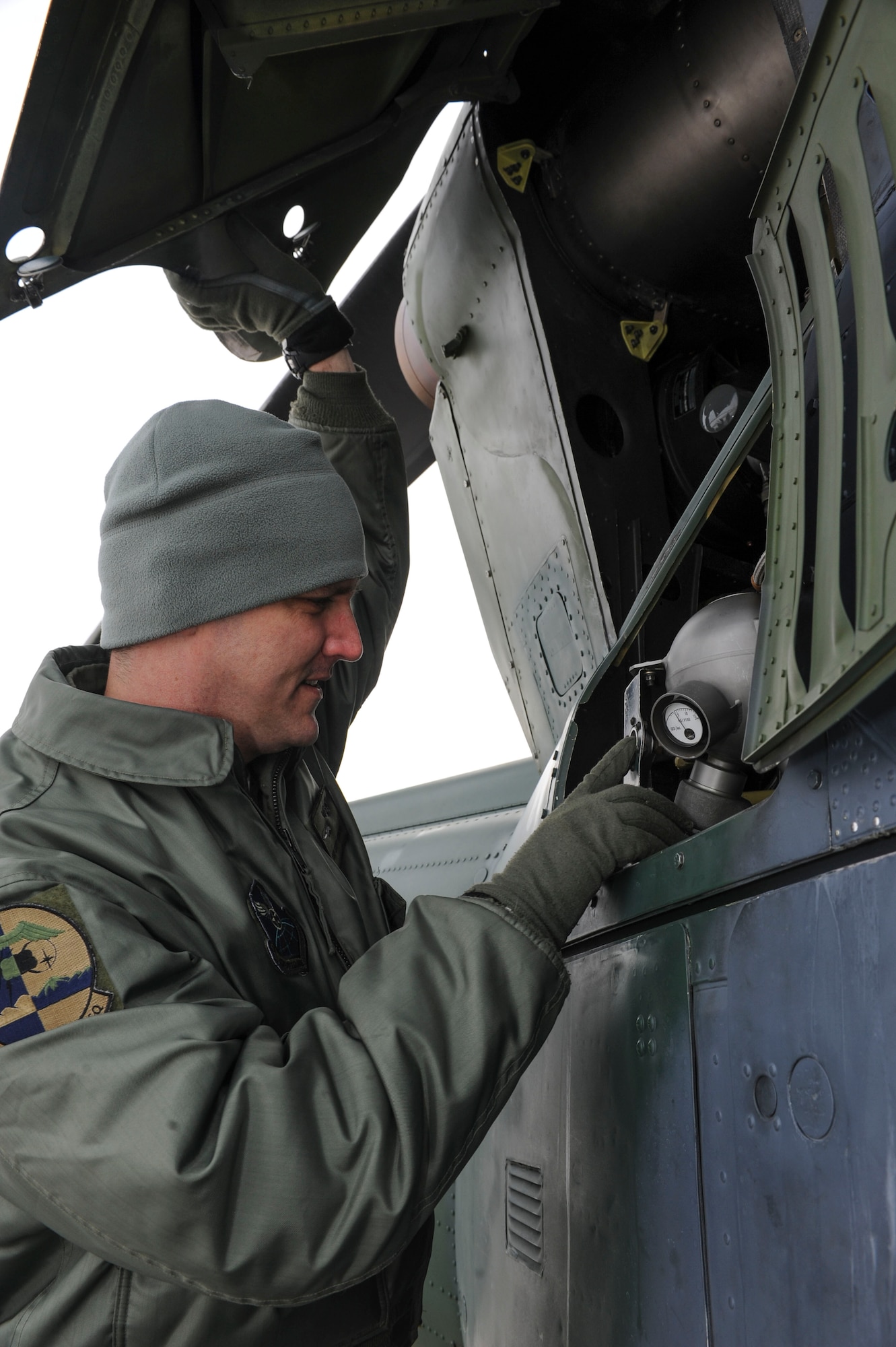 Tech. Sgt. Scott Grubaugh, 54th Helicopter Squadron special mission aviator, checks the engine compartment of a UH-1N helicopter on Minot Air Force Base, N.D., Jan. 21, 2014. Pre-flight checks are conducted before every mission to ensure the aircraft is in the proper condition for flight. (U.S. Air Force photo/Senior Airman Stephanie Morris)