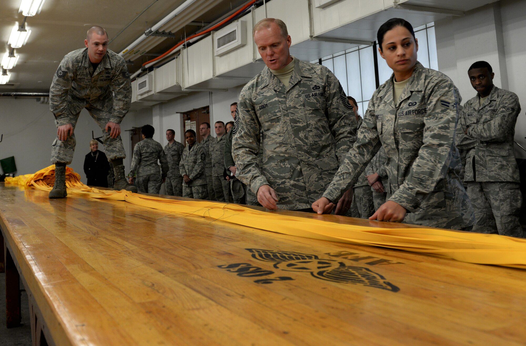 Chief Master Sgt. of the Air Force James Cody observes the procedures for packing a parachute on Barksdale Air Force Base, La., Jan. 23, 2015. While experiencing some of the tasks Airmen complete daily, Cody shared his views on the challenges and opportunities facing today's Airmen. (U.S. Air Force photo/Airman 1st Class Curt Beach)