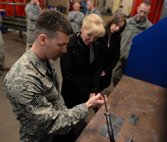 Senior Airman William Greenway, 2nd Maintenance Squadron metals technician journeyman, demonstrates welding procedures with retired Chief Master Sgt. Athena Cody, wife of Chief Master Sgt. of the Air Force James Cody, on Barksdale Air Force Base, La., Jan. 23, 2015. During her two-day visit, Cody toured the base and visited several different squadrons to speak with Airmen and experience their day-to-day duties. (U.S. Air Force photo/Airman 1st Class Curt Beach)