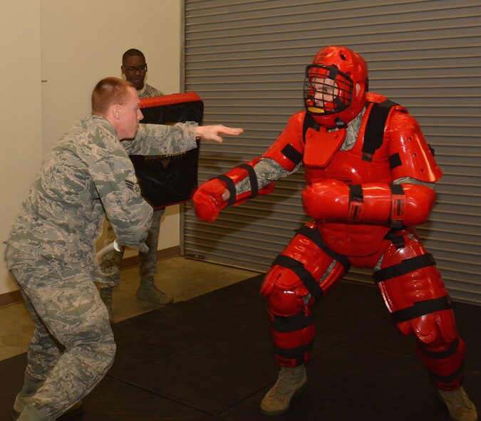 Members of the 932nd Security Forces Squadron look on as Col. Karl Goerke, in the Red Man suit, practices tactical maneuvers with Senior Airman Dakota Fehrmann during the exciting but intense January Unit Training Assembly. (U.S. Air Force Photo/Staff Sgt. Amber Hodges)