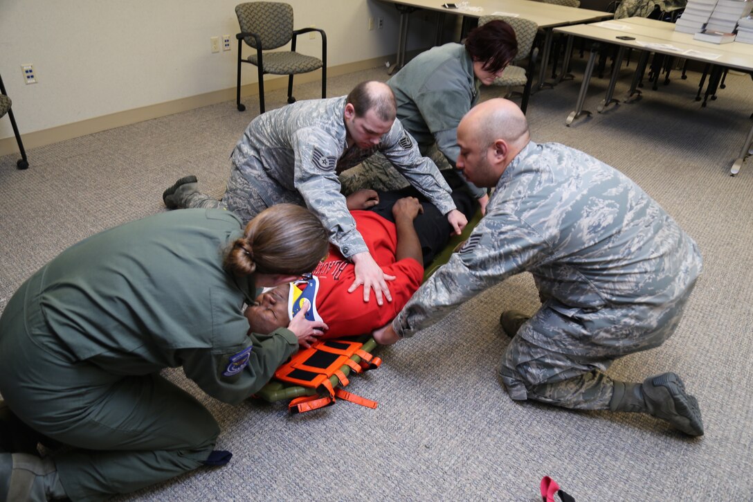 Aeromedical Evacuation Squadron members work together during annual Emergency Medical Technician training on proper procedures for patient assessment and trauma at the 932nd Airlift Wing, Scott Air Force Base, Ill. (U.S. Air Force photo/Tech. Sgt. Christopher Parr)