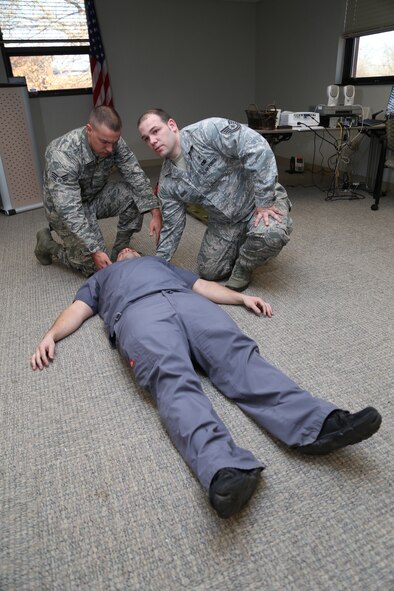 Tech. Sgt. Trenton Seibel, second from the left, instructs members of the Aeromedical Evacuation Squadron during annual Emergency Medical Technician training on proper procedures for patient assessment and trauma Jan. 9, 2014, Scott Air Force Base, Ill. (U.S. Air Force photo/Tech. Sgt. Christopher Parr)