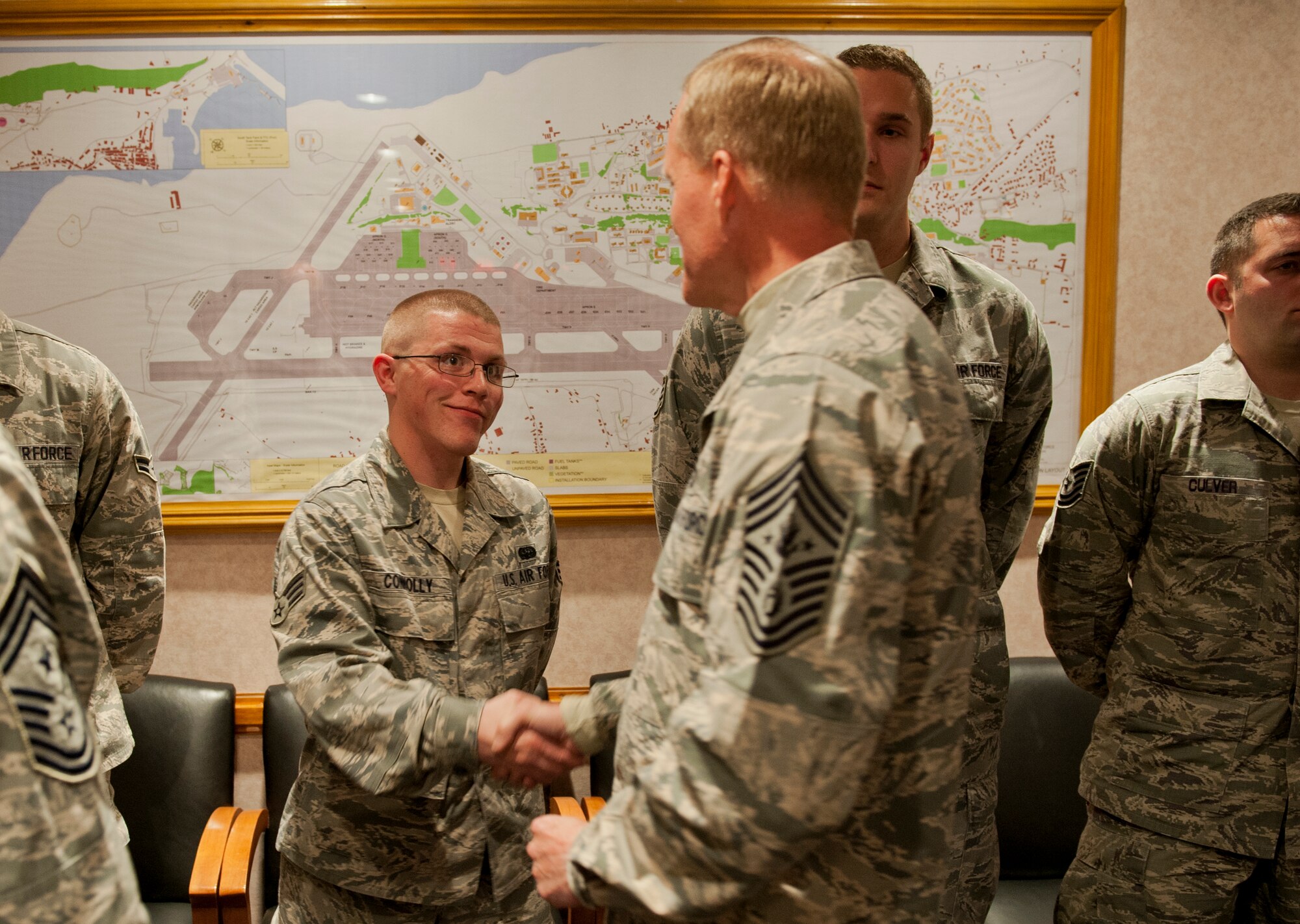 Chief Master Sgt. of the Air Force James A. Cody presents a coin to Senior Airman Sean Connolly, 65th Communications Squadron, Lajes Field, Azores, Portugal, on January 26, 2015. Cody is currently on a tour of bases within the United States Air Forces in Europe command to express his gratitude to Airmen, listen to their concerns and answer their questions. (U.S. Air Force photo/Staff Sgt. Zachary Wolf/Released)