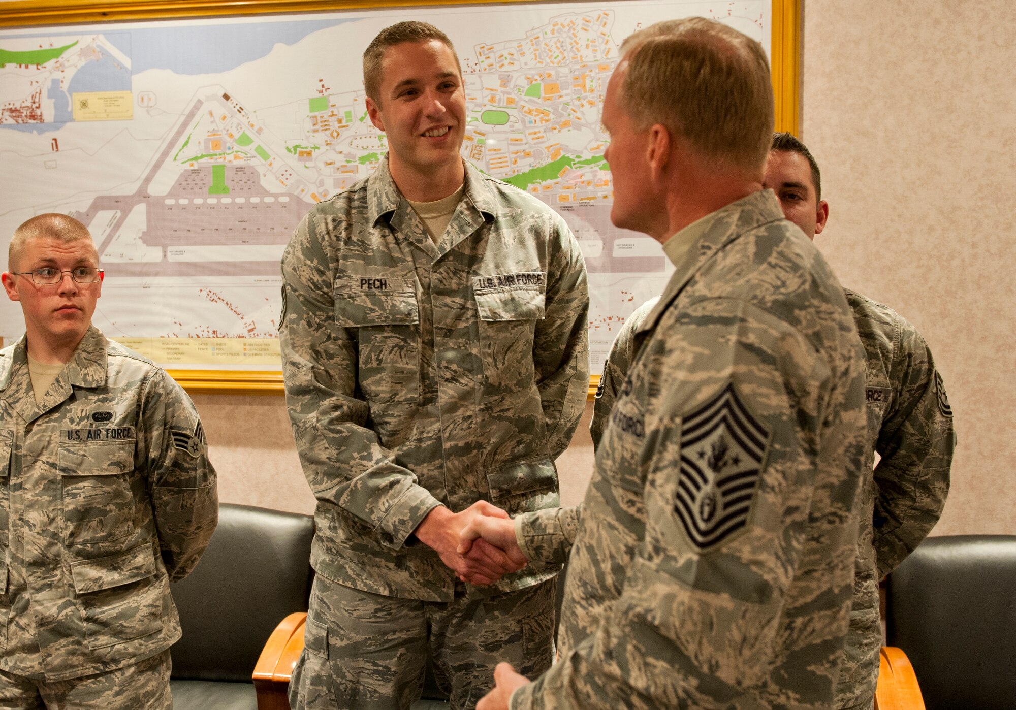 Chief Master Sgt. of the Air Force James A. Cody presents a coin to Staff Sgt. Gabriel Pech, 65th Medical Operations Squadron, Lajes Field, Azores, Portugal, on January 26, 2015. Cody is currently on a tour of bases within the United States Air Forces in Europe command to express his gratitude to Airmen, listen to their concerns and answer their questions. (U.S. Air Force photo/Staff Sgt. Zachary Wolf/Released)
