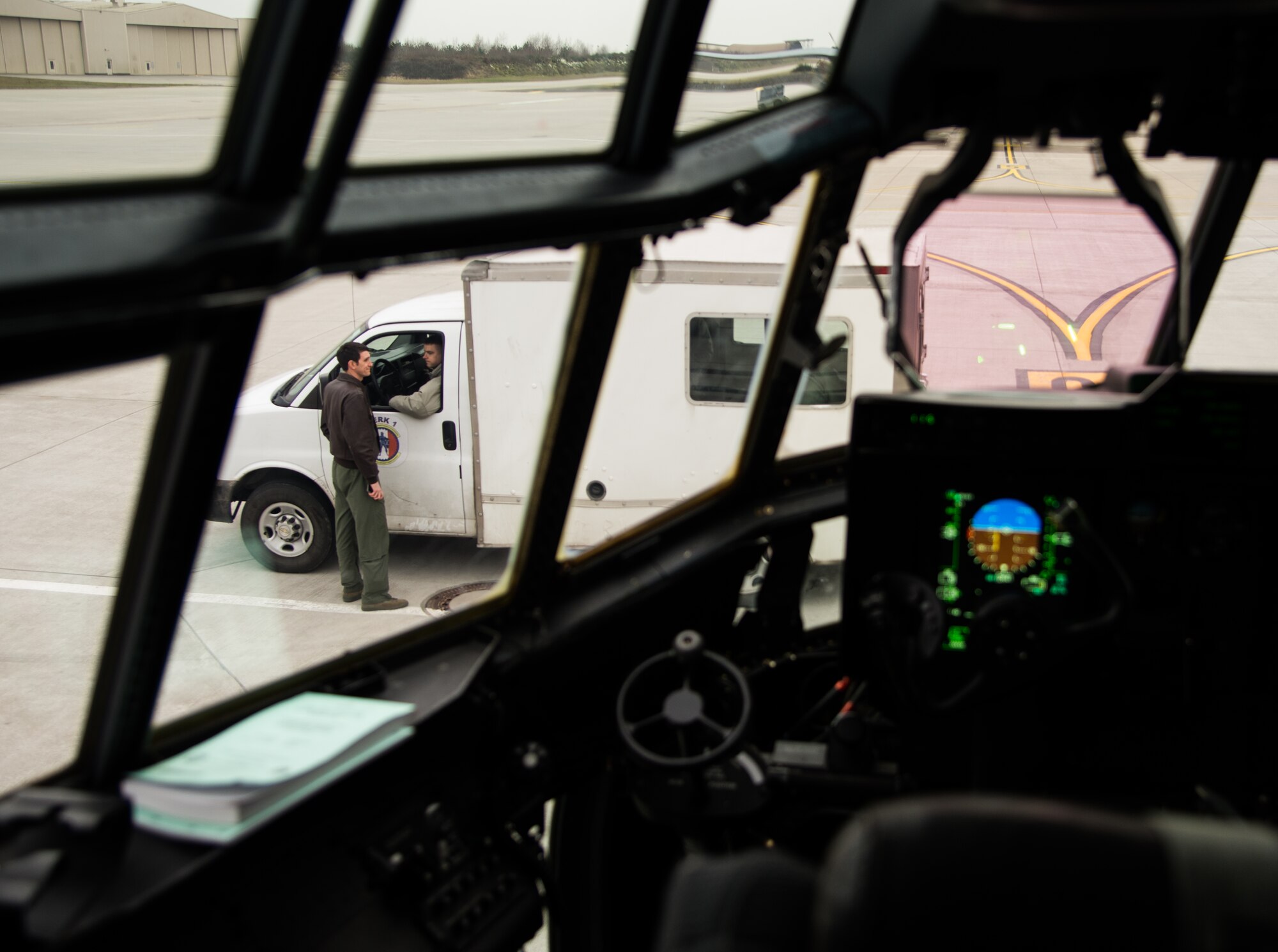 Capt. Kenneth Jubb, 37th Airlift Squadron pilot, talks to maintainers before pre-inspecting a C-130J Super Hercules for a training mission Jan. 22, 2015, at Ramstein Air Base, Germany. The intent of the mission was to train Jubb and the co-pilot in flying at 7,000 feet as well as performing a simulated cargo drop to maintain proficiency. (U.S. Air Force photo/Senior Airman Jonathan Stefanko)