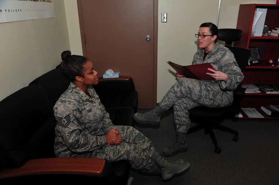Staff Sgt. Jeannie Hackett, 51st Medical Operations Squadron, certified alcohol and drug counselor, speaks with Tech. Sgt. La’Kisha Tucker, 51st MDOS alcohol and drug abuse prevention and treatment NCO in charge, about how to handle work a case when taking it to the next appropriate level of care Jan. 9, 2014, at Osan Air Base, Republic of Korea. Hackett is this week’s Airman Spotlight winner. (U.S. Air Force photo by Senior Airman David Owsianka)