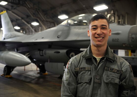 U.S. Air Force Airman 1st Class Kevin Riker, 35th Aircraft Maintenance Squadron assistant dedicated crew chief, poses in front of an F-16 Fighting Falcon at Misawa Air Base, Japan, Jan. 27, 2015. Riker is part of a team of crew chiefs that performs and oversees everyday maintenance to aircraft including refueling, changing tires and brakes, servicing engine oil and hydraulic fluid, and aircraft inspections. (U.S. Air Force photo by Airman 1st Class Jordyn Rucker/Released)