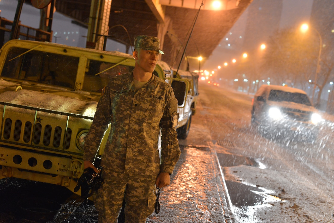 Soldiers with Joint Task Force Empire Shield work with members of the New York City Fire Department during a major blizzard Jan. 26, 2015. New York Air National Guard photo by Air Force Staff Sgt. Christopher S. Muncy