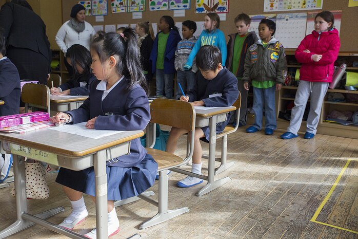 Children and staff from the School Age Care center aboard Marine Corps Air Station Iwakuni, Japan, observe the classes at Nishiki Seiryu Elementary School in Iwakuni City, Jan. 23, 2015. SAC visited the school to compare Japanese and American schooling.